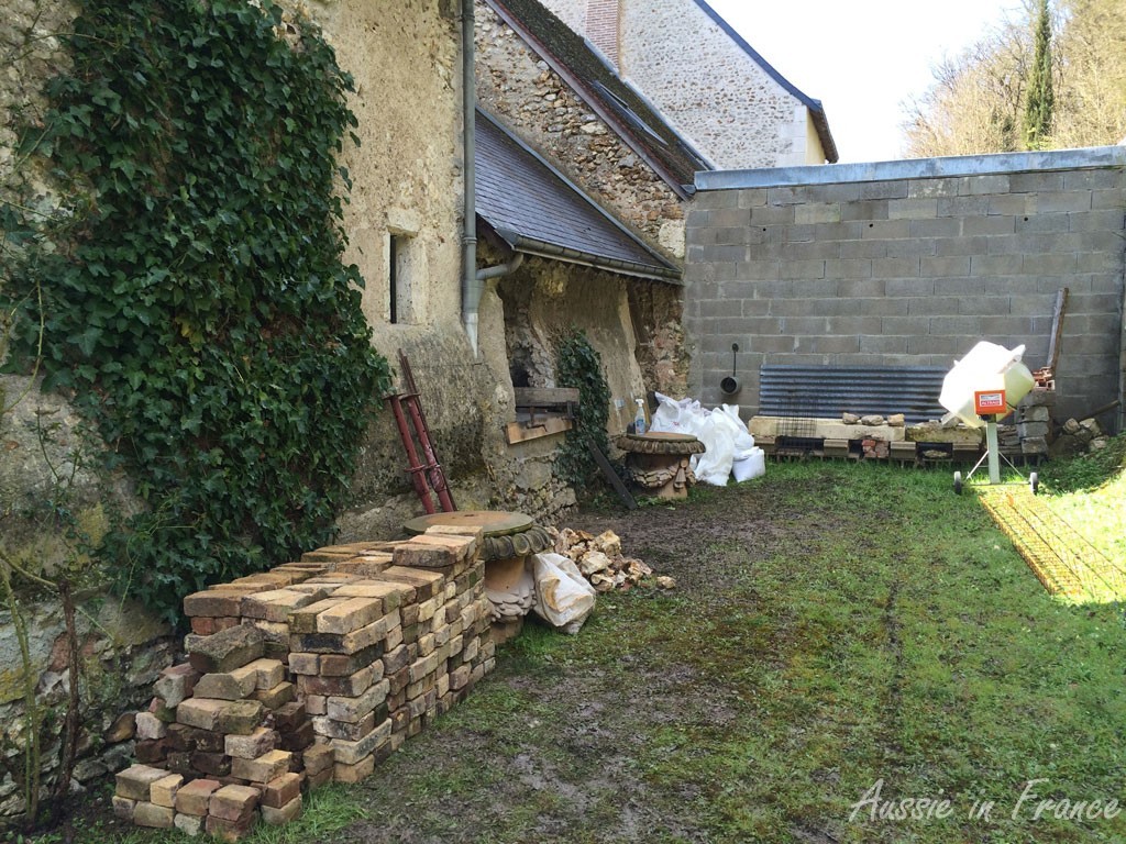 The bricks unloaded. You can see the stone sills at the end of the garden. The "practice" window is the last one on the right.